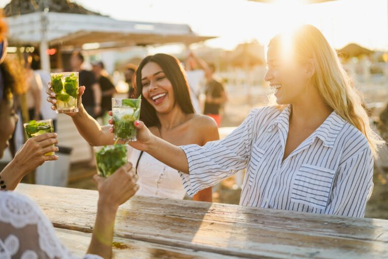 Happy,Girls,Cheering,With,Mojitos,On,The,Beach,At,Chiringuito