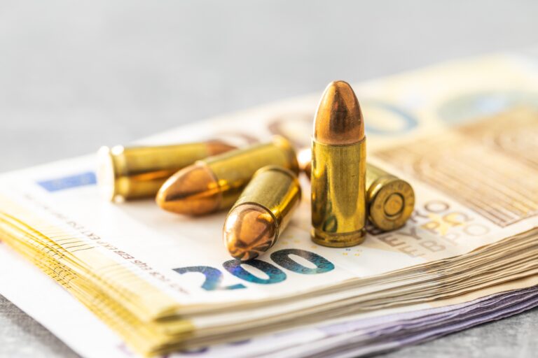 Euro,Banknotes,And,Bullets,On,Gray,Table.