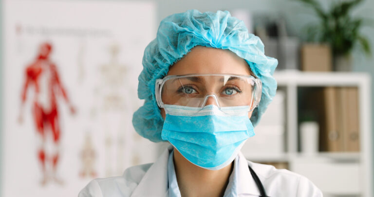 Close,Up,Portrait,Of,Female,Doctor,Wearing,Protective,Mask,And