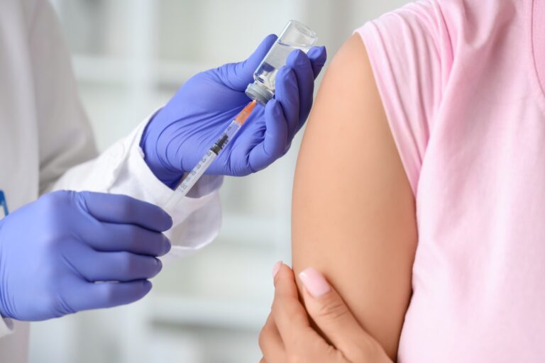 Young,Woman,Getting,Vaccine,From,Doctor,In,Clinic,,Closeup
