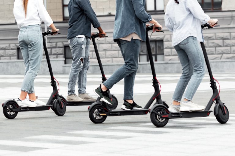 Closeup,Of,Unrecognizable,Diverse,Group,Of,Stylish,Teenagers,Riding,Motorized