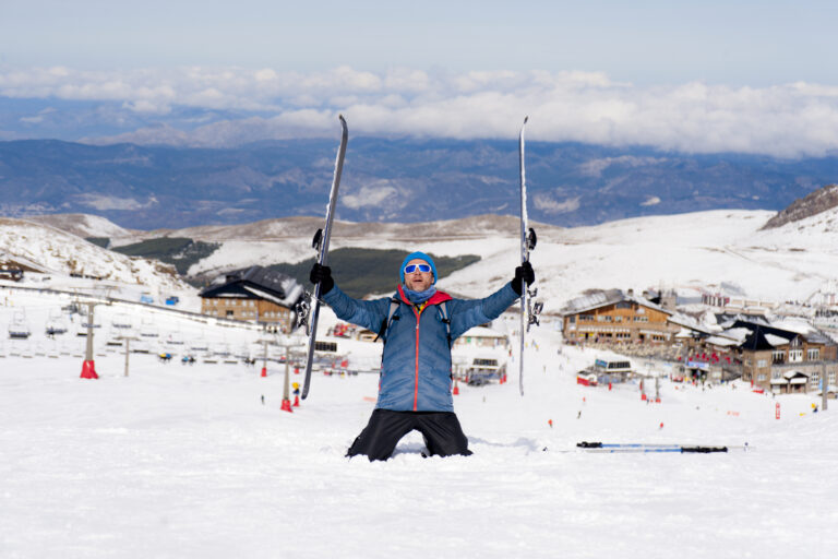 Young,Happy,Man,In,Winter,Clothes,And,Ski,Gear,Posing