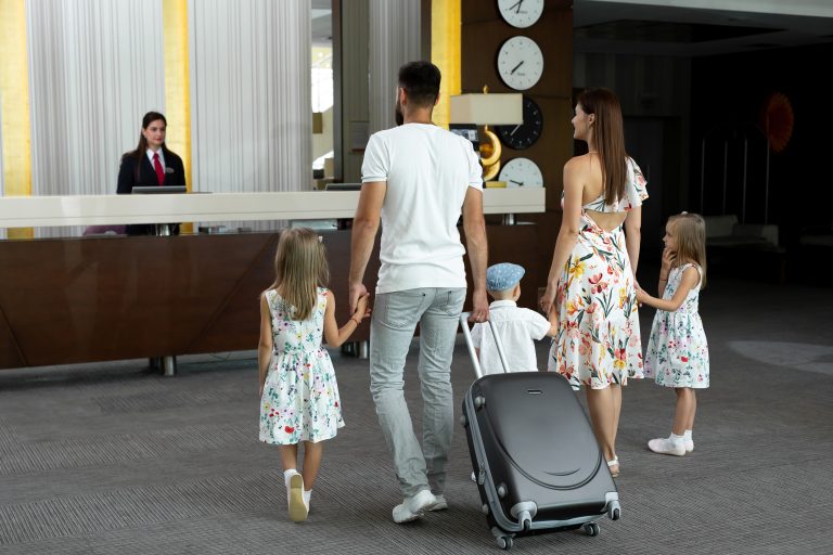 Family,Of,Five,Enters,To,The,Hotel,Lobby,To,Check