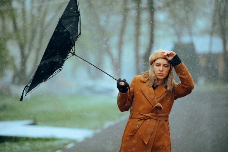 Woman,With,An,Umbrella,Broken,By,A,Snowstorm,Unhappy,Person